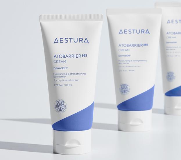Visible DermaOn micro-capsules dissolving smoothly inside Aestura Atobarrier 365 Cream on fingers